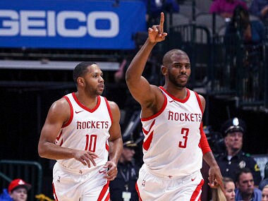 Houston Rockets guard Chris Paul (3) gestures after a basket guard Eric Gordon (10) in the second half of an NBA basketball game Sunday, March 11, 2018 in Dallas. (AP Photo/ Richard W. Rodriguez)