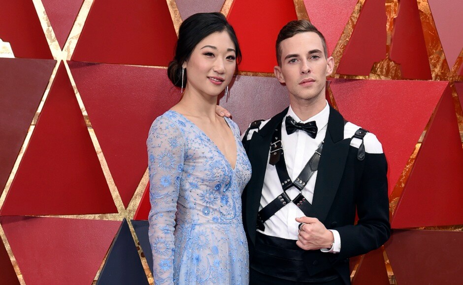Mirai Nagasu, left, and Adam Rippon arrive at the Oscars on Sunday, 4 March 2018, at the Dolby Theatre in Los Angeles. Olympian Rippon's custom Moschino leather harness and tuxedo was quite the talking point. AP Photo