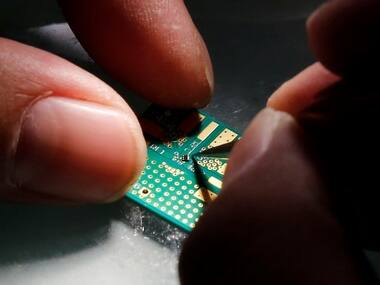 A researcher plants a semiconductor. Reuterrs