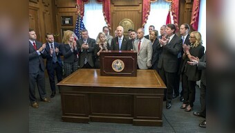 Florida governor Rick Scott signs gun restrictions three weeks after Parkland high school attack; NRA files lawsuit to block law