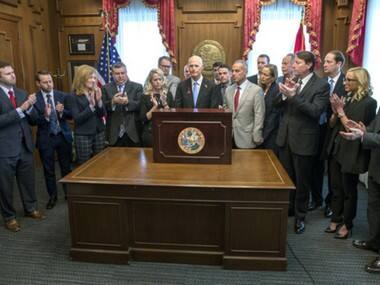Florida governor Rick Scott signs gun restrictions three weeks after Parkland high school attack; NRA files lawsuit to block law