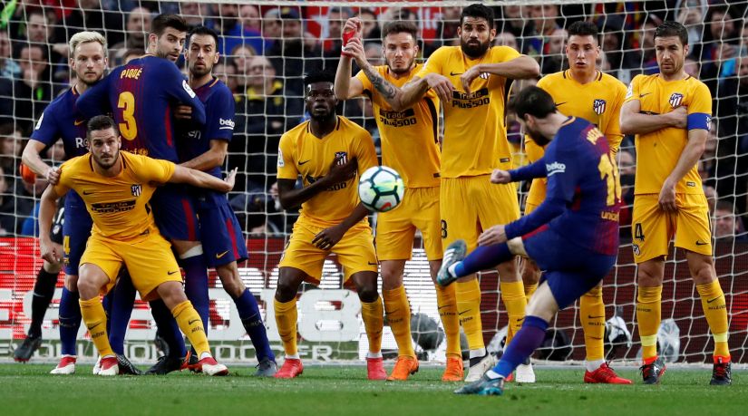 Barcelonas Lionel Messi scores their only goal against Atletico Madrid from a free-kick. Reuters