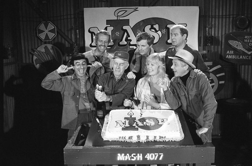Back row (extreme right): David Ogden Stiers and MASH cast members celebrate during a party on the set of the popular CBS program in Los Angeles. AP