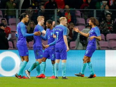 Netherlands' Virgil van Dijk celebrates scoring their third goal with teammates. Reuters
