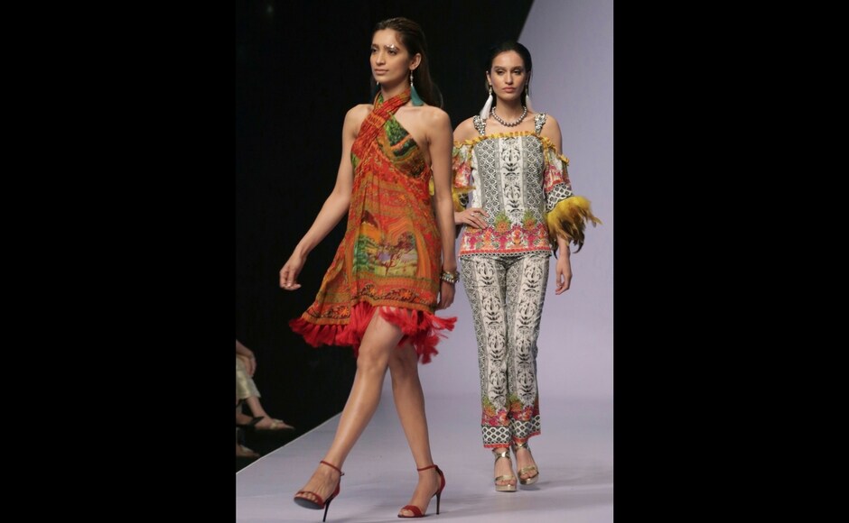 Models present creations by Pakistani label 'SO KAMAL'/AP Photo, K.M. Chaudary