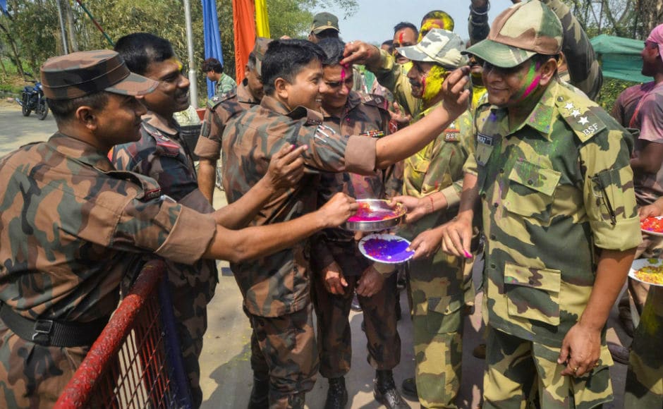 BSF soldiers exchanged sweets and gulal with thier Bangladeshi counterparts on the occasion of Holi at Akhaura border near Agartala in Tripura. The celebration of the festival started on Thursday evening with Holika dahan. PTI BSF soldiers exchanged sweets and gulal with thier Bangladeshi counterparts on the occasion of Holi at Akhaura border near Agartala in Tripura. The celebration of the festival started on Thursday evening with Holika dahan. PTI