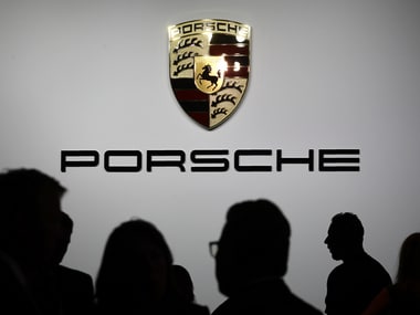 Members of the media and others gather for a news conference by Porsche. Image: Reuters