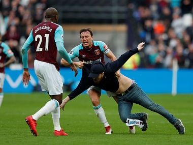 Soccer Football - Premier League - West Ham United vs Burnley - London Stadium, London, Britain - March 10, 2018 West Ham United's Mark Noble clashes with a fan who has invaded the pitch Action Images via Reuters/Peter Cziborra EDITORIAL USE ONLY. No use with unauthorized audio, video, data, fixture lists, club/league logos or "live" services. Online in-match use limited to 75 images, no video emulation. No use in betting, games or single club/league/player publications. Please contact your account representative for further details. TPX IMAGES OF THE DAY - RC1445B9CF80