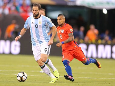 Jun 26, 2016; East Rutherford, NJ, USA; Argentina forward Gonzalo Higuain (9) dribbling the ball past Chile midfielder Arturo Vidal (8) during the first half of the championship match of the 2016 Copa America Centenario soccer tournament at MetLife Stadium. Mandatory Credit: Brad Penner-USA TODAY Sports - 9357651