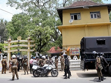 Police stand guard in parts of Sri Lanka on Thursday. AP