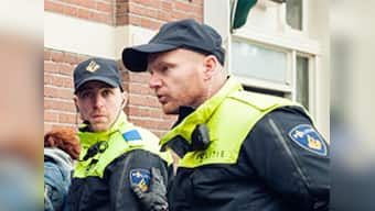 65-year-old activist jumps from public gallery onto floor of Dutch Parliament in apparent suicide attempt