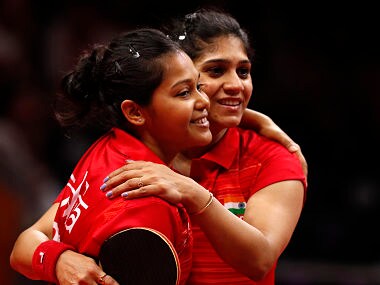 India's Mouma Das (L) and Madhurika Patkar (R) celebrate winning their womens team quarter-final table tennis match against Malaysia during the 2018 Gold Coast Commonwealth Games at the Oxenford Studios venue in Gold Coast on April 7, 2018. / AFP PHOTO / ADRIAN DENNIS