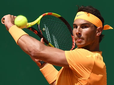 Spain's Rafael Nadal plays a backhand return to Austria's Dominic Thiem during their singles tennis match at the Monte-Carlo ATP Masters Series tournament in Monaco on April 20, 2018. / AFP PHOTO / YANN COATSALIOU