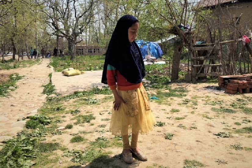 Arbeen Lone outside her neighbours’ house, where she will live till her family finds a new house. Firstpost/Sameer Yasir