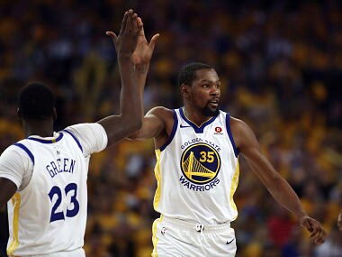 Golden State Warriors' Kevin Durant (35) celebrates a score with Draymond Green, left, as San Antonio Spurs' Rudy Gay (22) watches during the second half in Game 1 of a first-round NBA basketball playoff series Saturday, April 14, 2018, in Oakland, Calif. (AP Photo/Ben Margot)