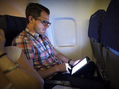 A passenger uses a tablet on an American Airlines airplane. Image: Reuters