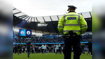 Premier League: Pep Guardiola defends Manchester City fans' 'happy' pitch invasion after win over Swansea at Etihad