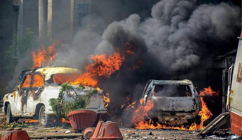 Smoke billows out of burning cars during 'Bharat Bandh' against the alleged 'dilution' of Scheduled Castes/Scheduled Tribes act, in Uttar Pradesh's Muzzaffarnagar. PTI