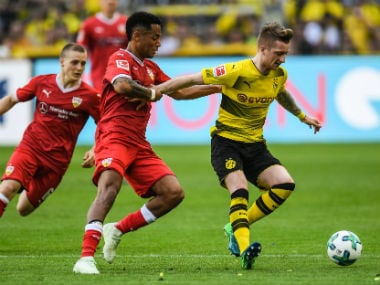 Stuttgart's Dennis Aogo and Dortmund's German forward Marco Reus vie for the ball during their Bundesliga match on Sunday. AFP