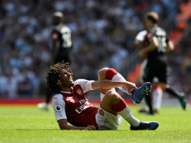 Arsenal's Mohamed Elneny reacts after sustaining an injury. Reuters