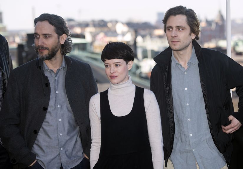 From left, actors Fede Alvarez, Claire Foy and Sverrir Gudnason pose for the media during a photocall for the film "The Girl in the Spider's Web", in Stockholm, Friday, April 13, 2018. (Fredrik Sandberg/TT News Agency via AP)