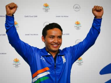 Jitu Rai celebrates winning the gold medal on the podium following the men's 10m air pistol shooting final. AFP 