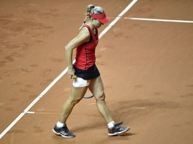 Angelique Kerber stops to play due to an injury on her right leg in the match against Anett Kontaveit. AFP