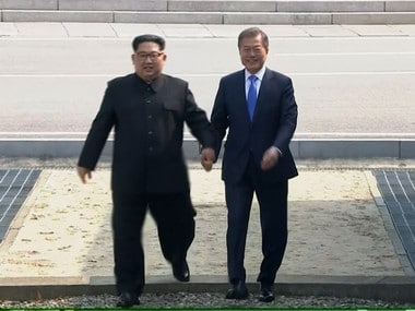 Kim Jong Un (left) crossing the border into South Korea, along with South Korean President Moon Jae-in. AP