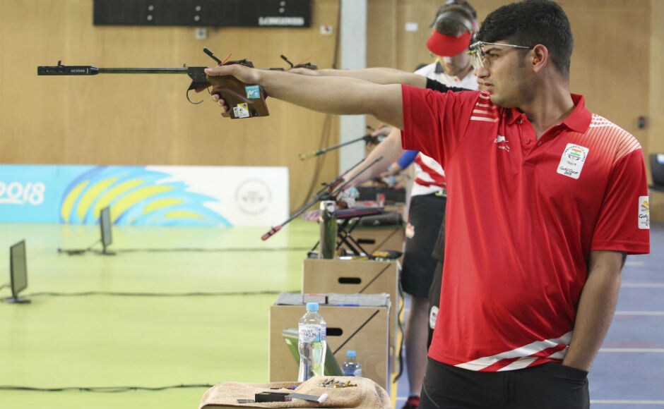Om Mitharval of India takes aim during the men's 50m Pistol final at the Belmont Shooting Centre. AP Om Mitharval of India takes aim during the men's 50m Pistol final at the Belmont Shooting Centre. AP