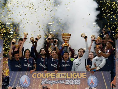 aris Saint-Germain's Thiago Silva lifts the trophy as his team celebrates after victory. Reuters
