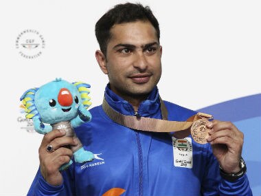 Ravi Kumar of India poses with his bronze medal on the podium after the men's 10m Air Rifle finals. AP