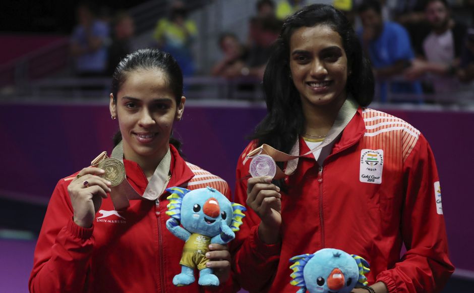 Saina Nehwal (L) and PV Sindhu (R) pose for a photograph after their badminton women's singles final at Gold Coast. AP Saina Nehwal (L) and PV Sindhu (R) pose for a photograph after their badminton women's singles final at Gold Coast. AP