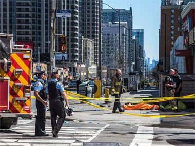 A body lies covered on the sidewalk in Toronto after a van mounted a sidewalk crashing into a number of pedestrians on Monday. AP