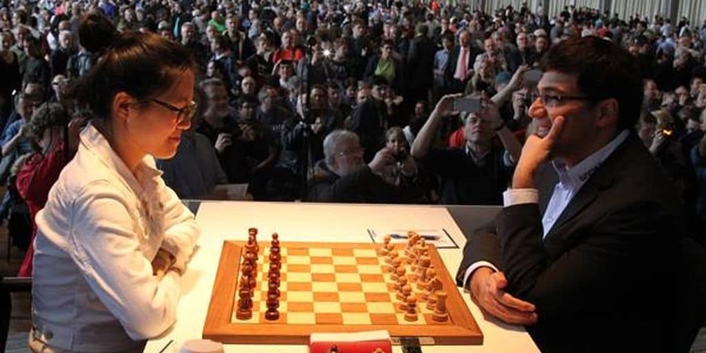 Reigning chess world champion Magnus Carlsen, right, from Norway, plays  Italian-American challenger Fabiano Caruana in the first five minutes of  round three of their World Chess Championship Match in London, Monday, Nov.