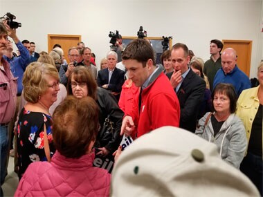 Attorney Bryan Steil, center, a former driver for House Speaker Paul Ryan, talks to people gathered at a news conference. AP