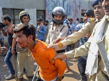 Police personnel detain a protester in Gwalior. PTI