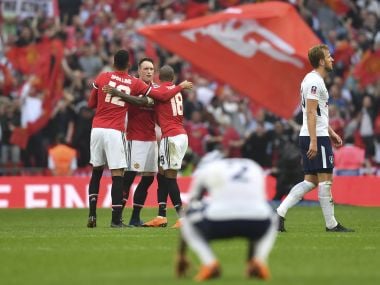 Manchester United players celebrate as Tottenham Hotspur's Harry Kane (right) walks off at the final whistle on Saturday. AFP