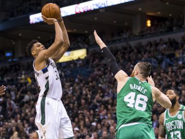 Milwaukee Bucks forward Giannis Antetokounmpo (left) shoots against Boston Celtics at BMO Harris Bradley Center. Reuters