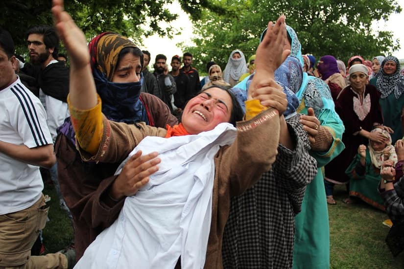 Umar Ahmad Kumar’s sister with his school uniform. Image courtesy Hilal Shah