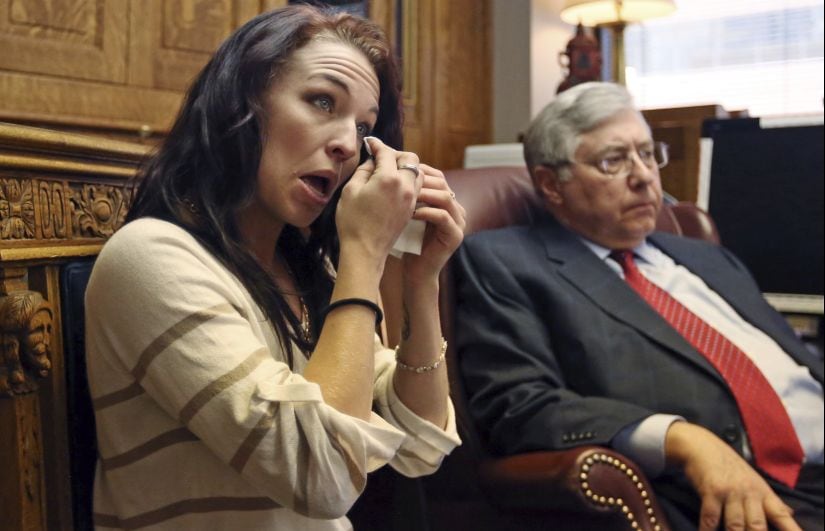 Kiersten Pyke wipes a tear from her face as she speaks during a press conference at her attorneys office Monday, May 7, 2018, in Salt Lake City. Pyke, a Utah woman who told police Tom Sizemore groped her at a photo shoot when she was 11, is suing the actor. The lawsuit filed Monday says the 2003 incident during production of the "Born Killers" movie left her with post-traumatic stress and drug and alcohol addiction. (AP Photo/Rick Bowmer)