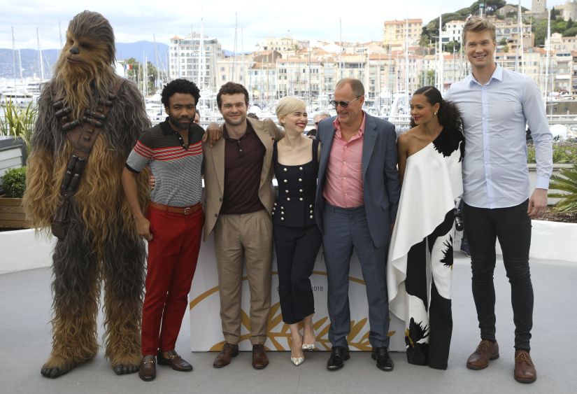A person wearing a costume of the character Chewbacca, from left, actors Donald Glover, Alden Ehrenreich, Emilia Clarke, Woody Harrelson, Thandie Newton and Joonas Suotamo pose for photographers during a photo call for the film 'Solo: A Star Wars Story' at the 71st international film festival, Cannes, southern France, Tuesday, May 15, 2018. (Photo by Vianney Le Caer/Invision/AP)