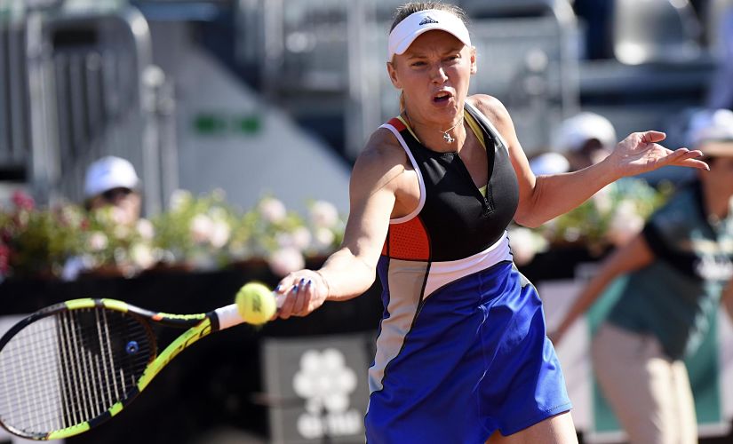 Denmark's Caroline Wozniacki returns the ball to Estonia's Anett Kontaveit during their quarterfinal match, at the Italian Open tennis tournament in Rome, Friday, May 18, 2018. (Claudio Onorati/ANSA via AP)