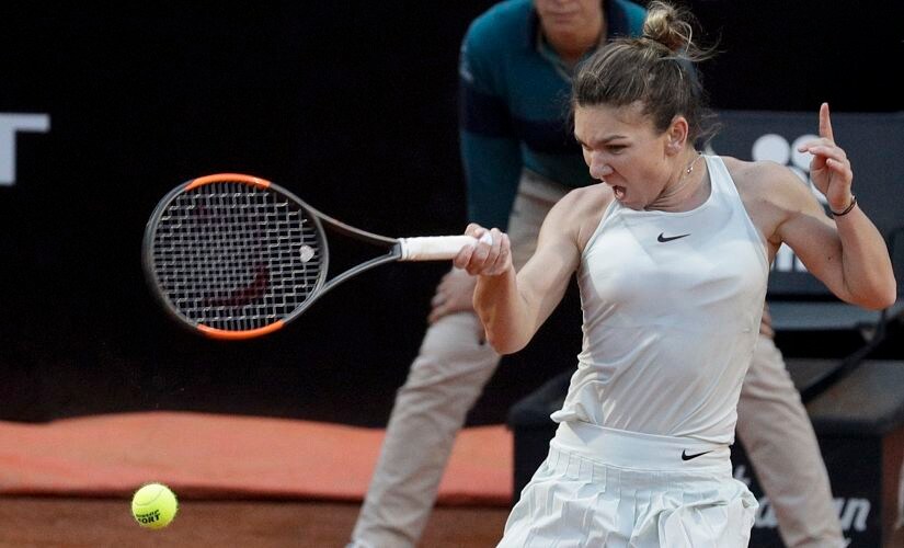 FILE - In this May 19, 2018, file photo, Romania's Simona Halep returns the ball to Russia's Maria Sharapova during their semifinal match at the Italian Open tennis tournament in Rome. Halep will be competing in the French Open tennis tournament that begins on Sunday, May 27.(AP Photo/Gregorio Borgia, File)