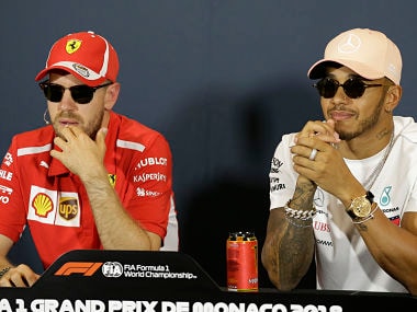 Ferrari driver Sebastian Vettel of Germany, left, is flanked by Mercedes driver Lewis Hamilton of Britain during a news conference, at the Monaco racetrack, in Monaco, Wednesday, May 23, 2018. The Formula one race will be held on Sunday. (AP Photo/Claude Paris)