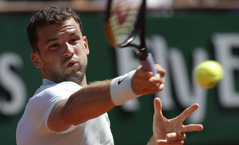 Bulgaria's Grigor Dimitrov returns the ball to Egypt's Mohamed Safwat during their first round match of the French Open tennis tournament at the Roland Garros Stadium, Sunday, May 27, 2018 in Paris. (AP Photo/Alessandra Tarantino)