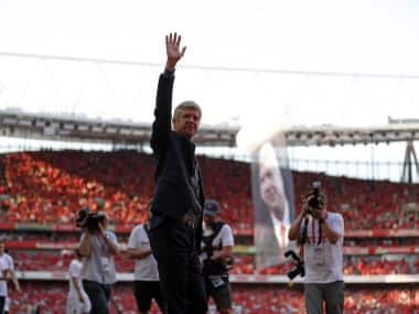Arsenal’s Arsene Wenger waves to supporters as he does a lap of honour at the Emirates Stadium. AFP