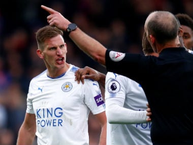 Leicester City's Marc Albrighton reacts after being sent off by referee Mike Dean. Reuters