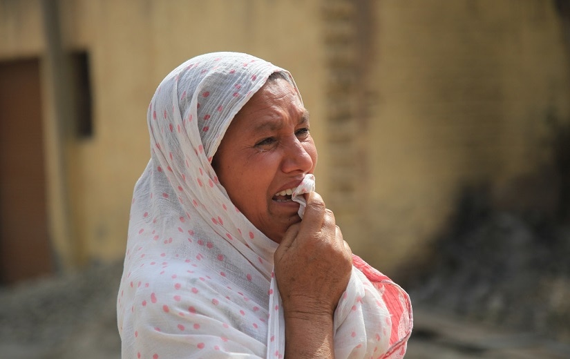 A wailing woman in Arnia area after her son was in injured in the firing. Image courtesy Mir Imran