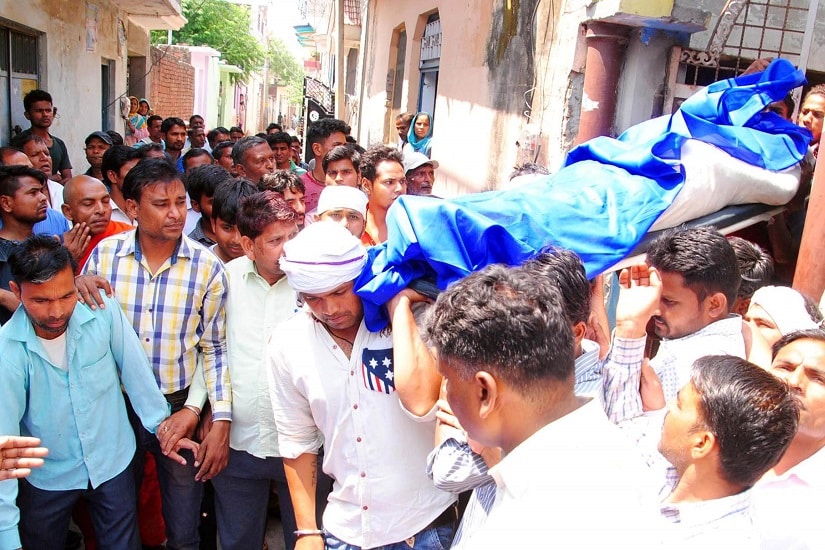 Bhim army member Sachin Walia's body draped in a blue shroud being taken for last rites. Image courtesy Kamal Bhargava