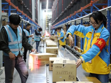 Employees scan parcels at a logistics base in China. Image: Reuters